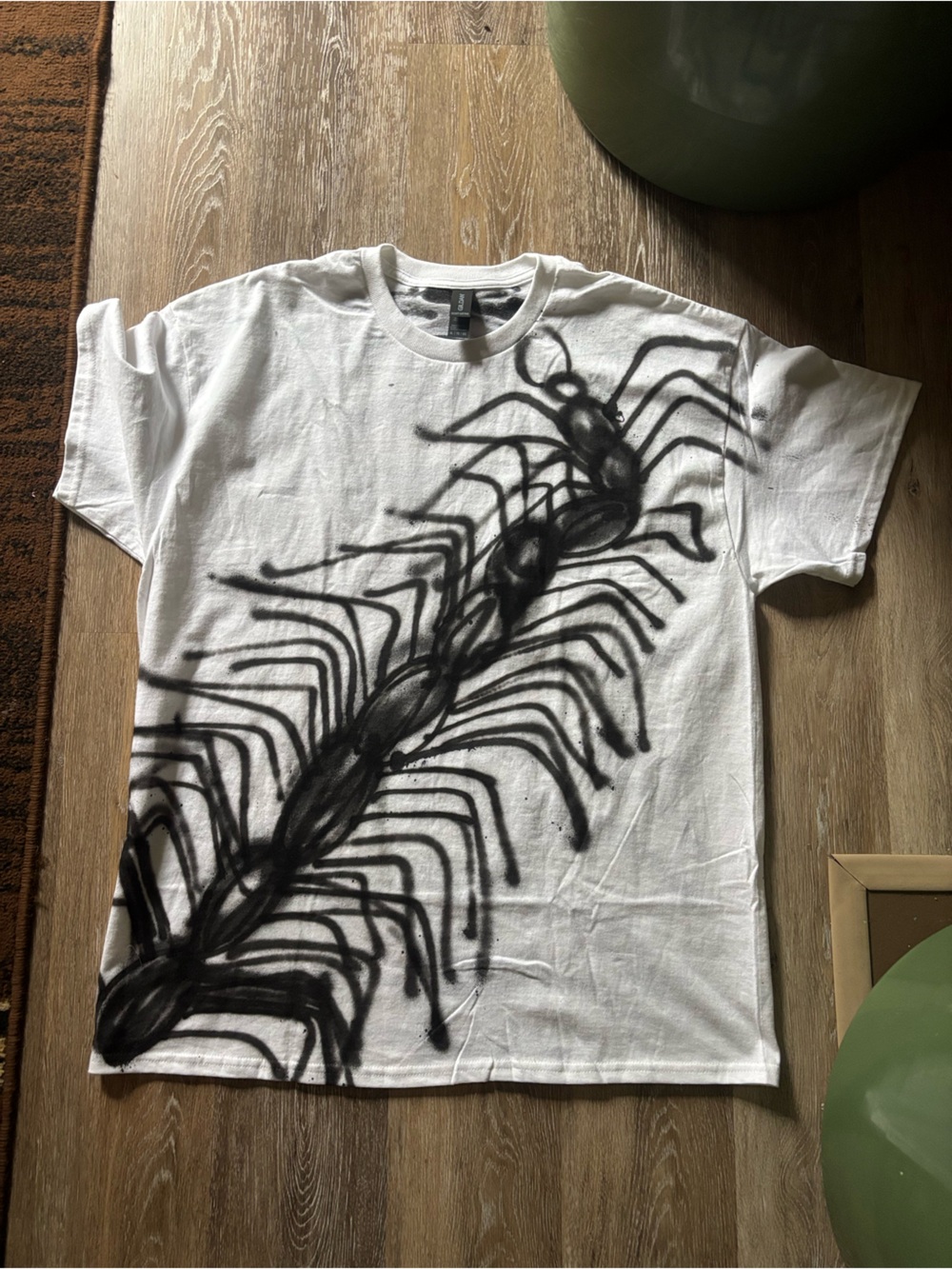 White Graphic Men’s T-Shirt with Black Centipede Design